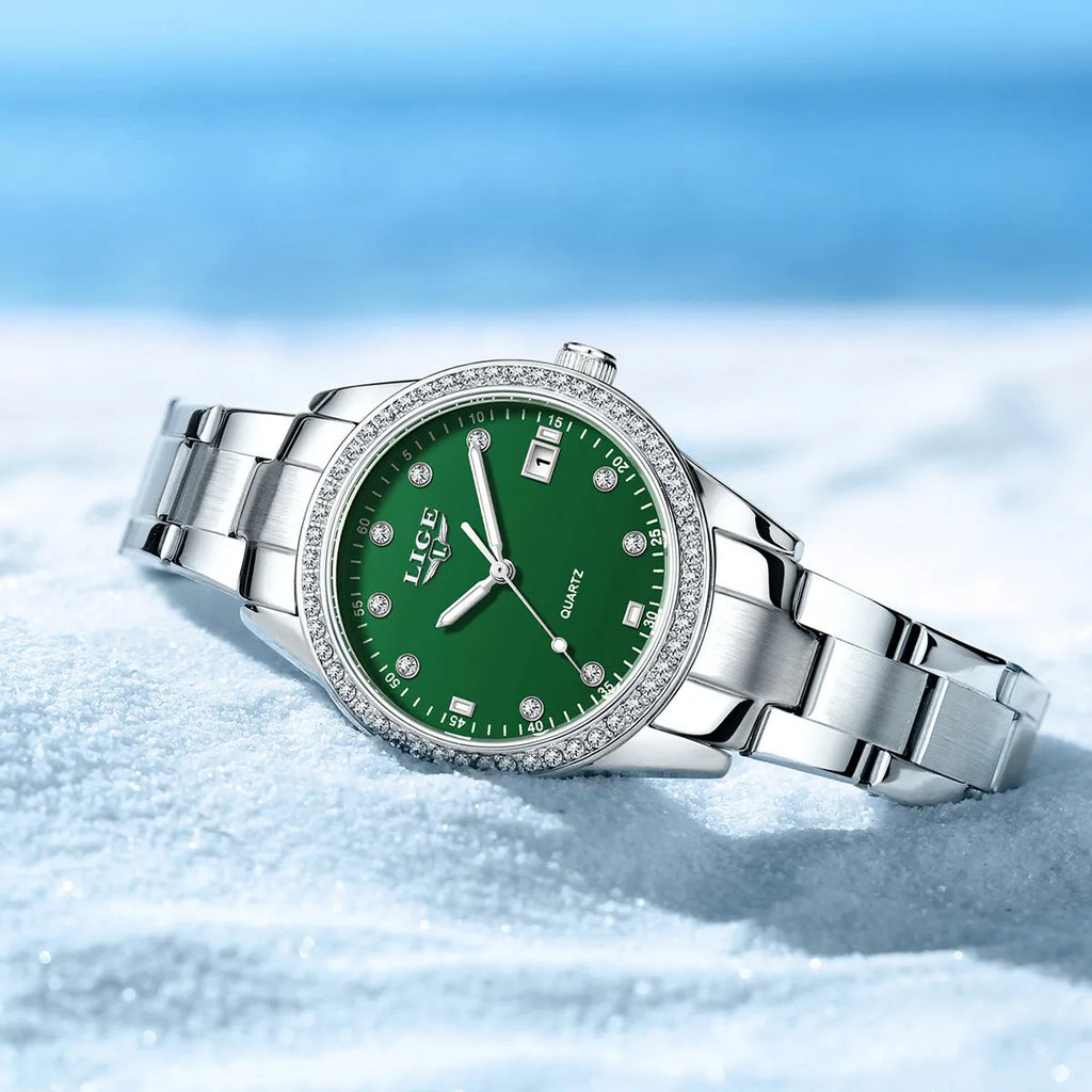 Silver stainless steel ladies watch with diamond bezel, luminous hands, and round 34mm dial.