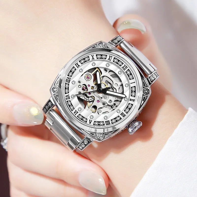 Mechanical wristwatch with luminous hands on a leather strap, shown in multiple colour variants.