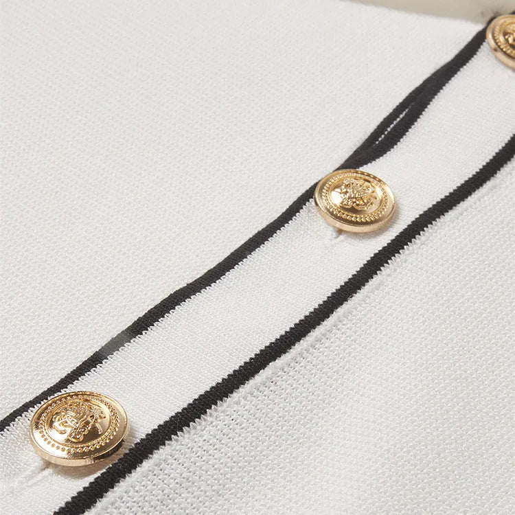 White short sleeve cardigan with dark contrast trim on the lapels.