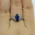 Silver alloy geometric hollow ring with zircon stone on white background, women's ring size 7