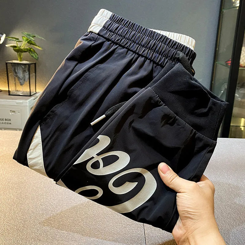 Man wearing black ultra-thin ice silk cotton ankle-banded cropped casual trousers