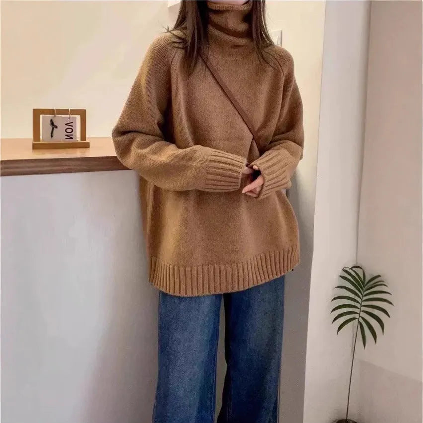 Women's loose turtleneck sweater with thick curling pile collar in red, camel, grey, or black.
