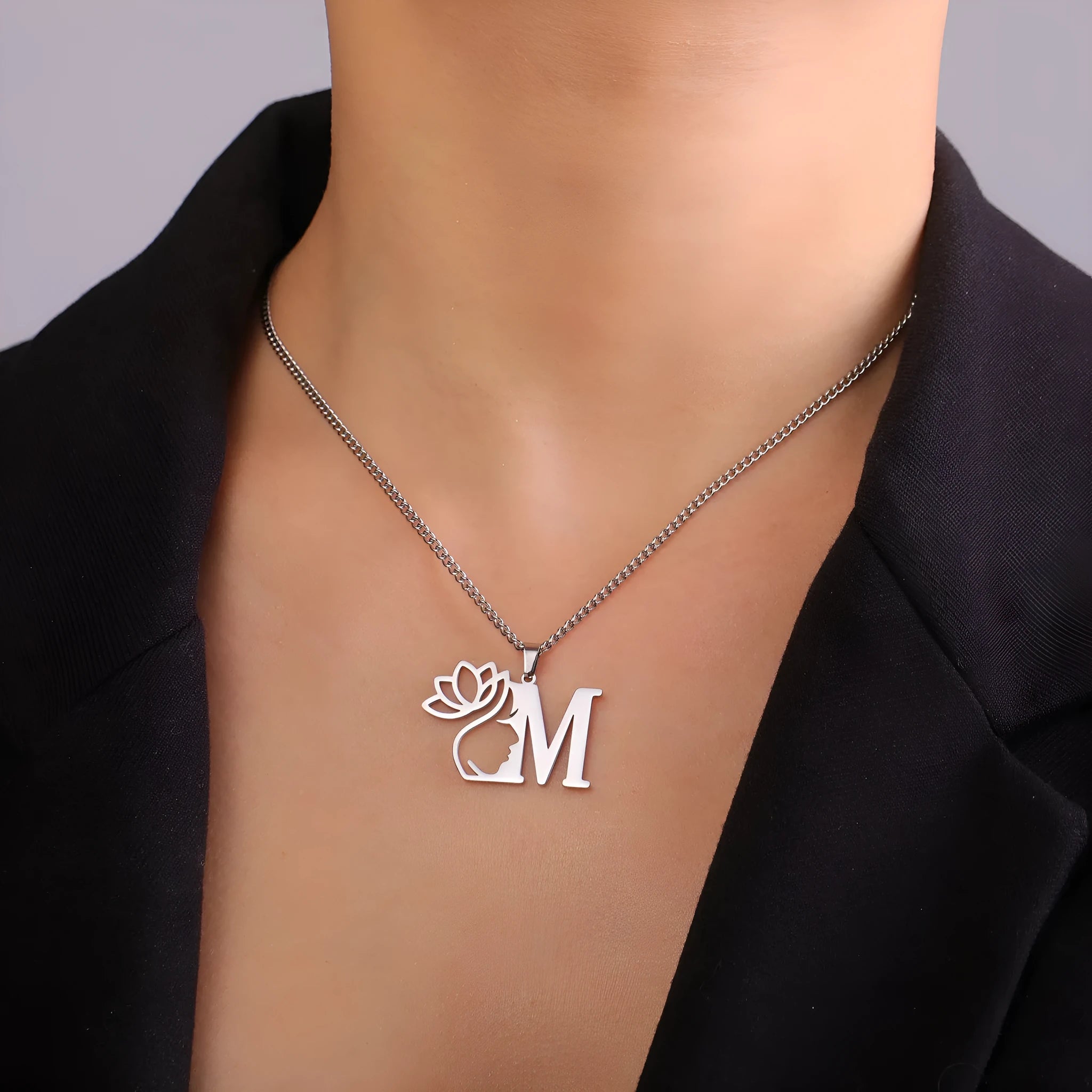 Stainless steel necklace with cross chain links and a single pendant in gold or silver finish.