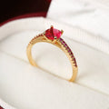 Geometric hexagon design copper zircon ring in various electroplated colours on a size guide.