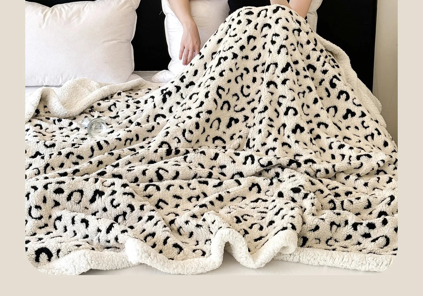 Double-layer cationic jacquard leopard print taffeta blanket in camel colour, folded to show texture.