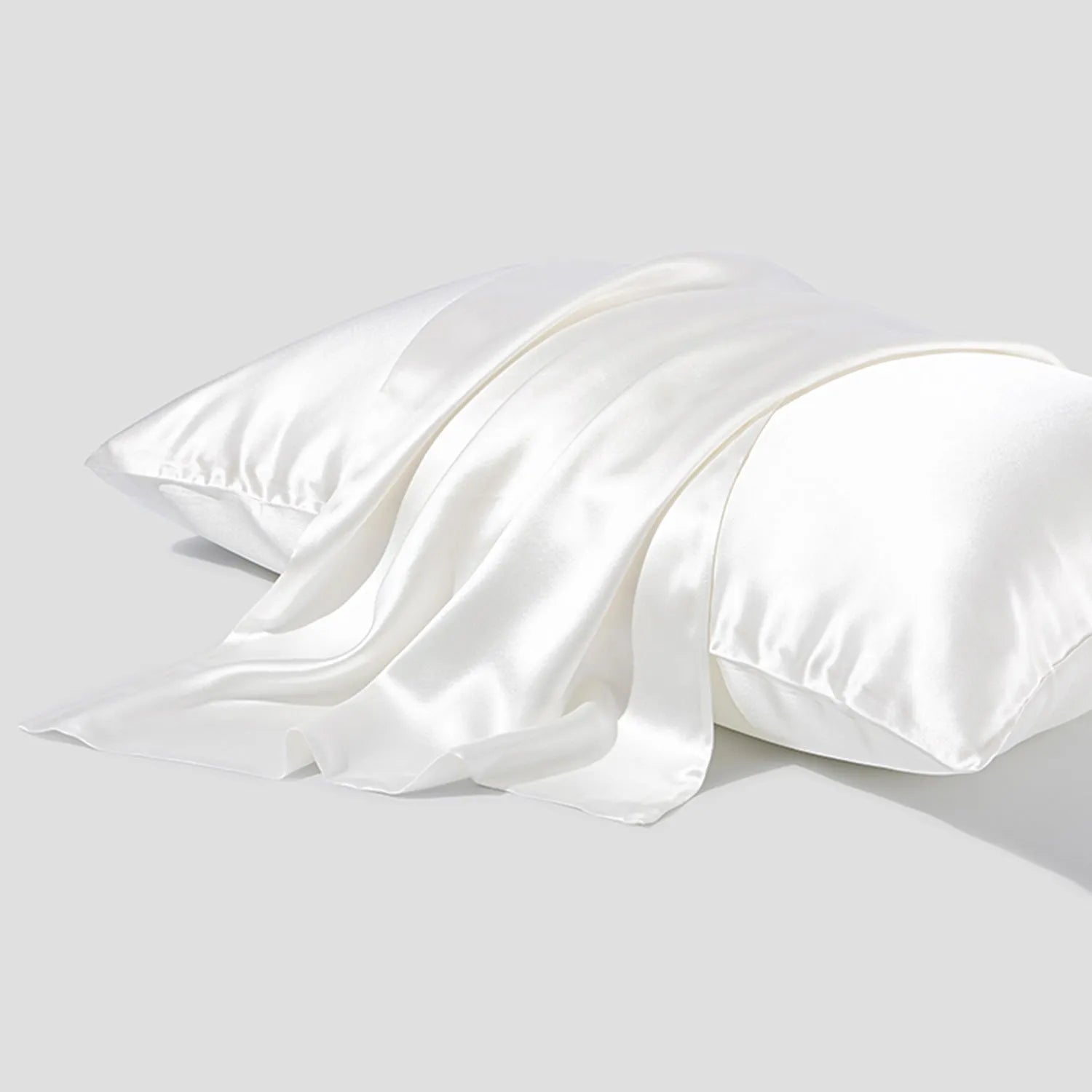 Dark gray 19 M silk envelope pillowcase with envelope closure on a bed.