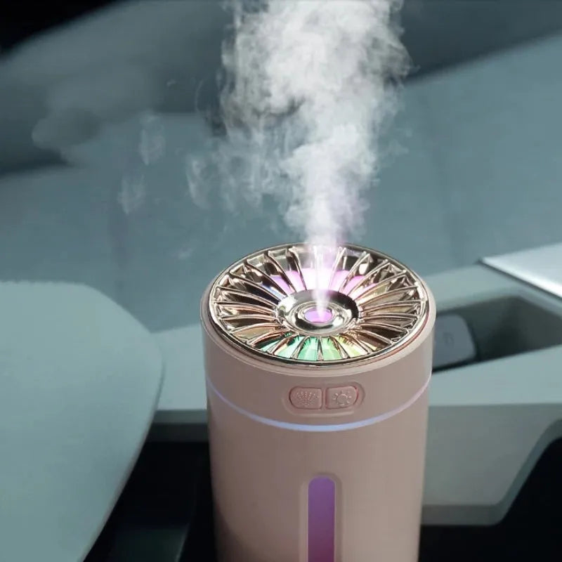 Black wireless ultrasonic humidifier with LED lights sitting in a car cup holder.