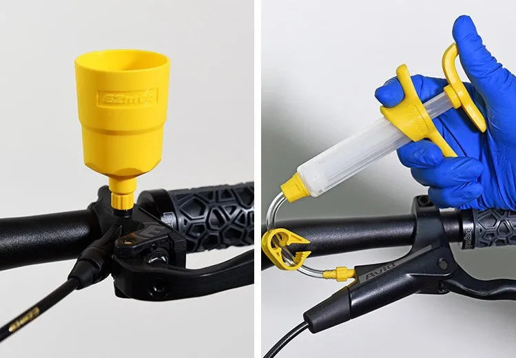 EZmtb bicycle hydraulic disc brake oil bleed kit tools with syringes, adapters, and wrenches on a workbench