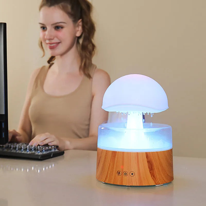 White cloud-shaped humidifier with falling water droplets and coloured night light