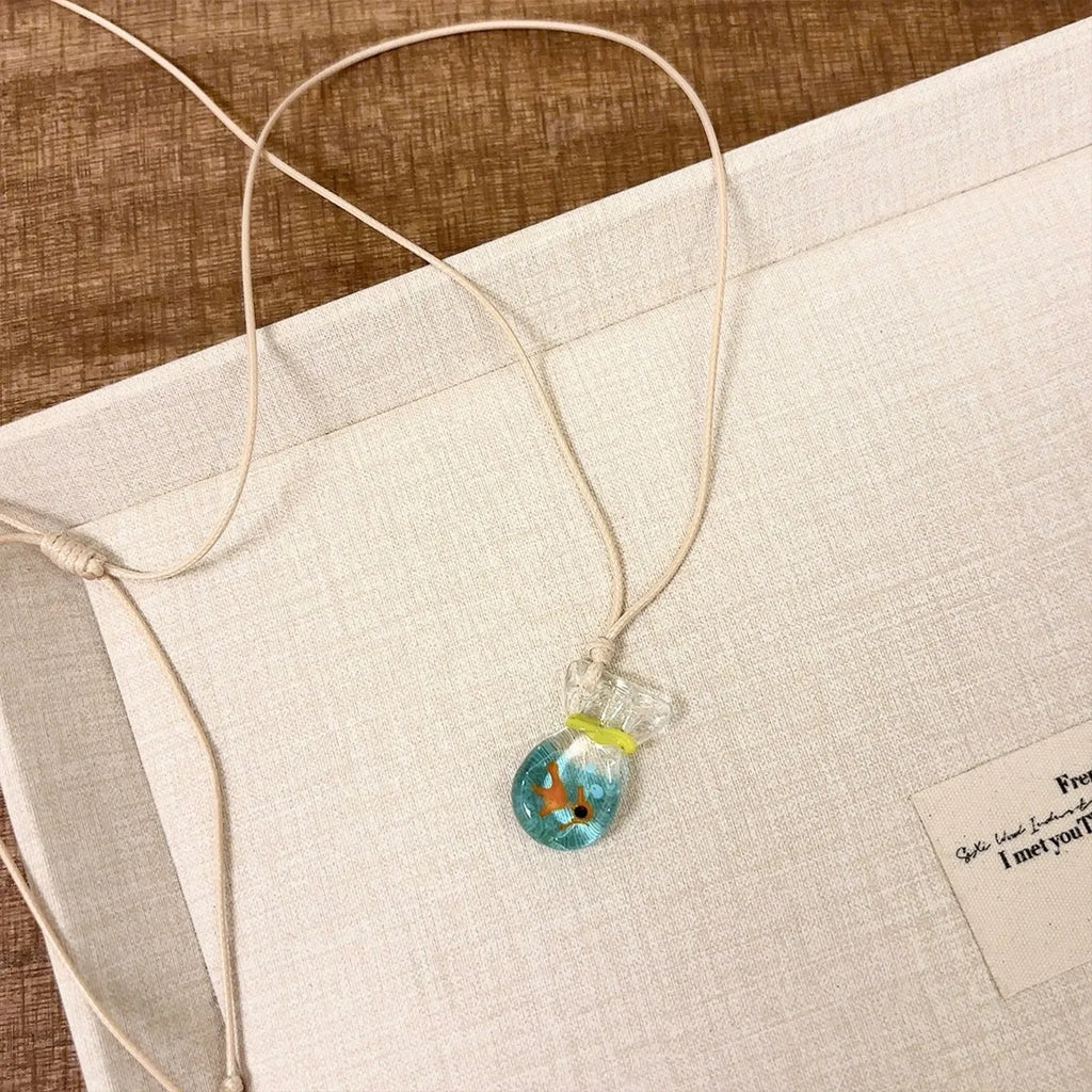 Women's joker charm pendant necklace in coloured glaze on a cotton and linen clavicle chain.