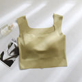 Women's non-marking sling vest in light blue, showing seamless design and abdominal length.