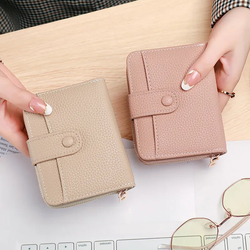Ladies' short wallet with lychee pattern in two-fold design showing interior compartments
