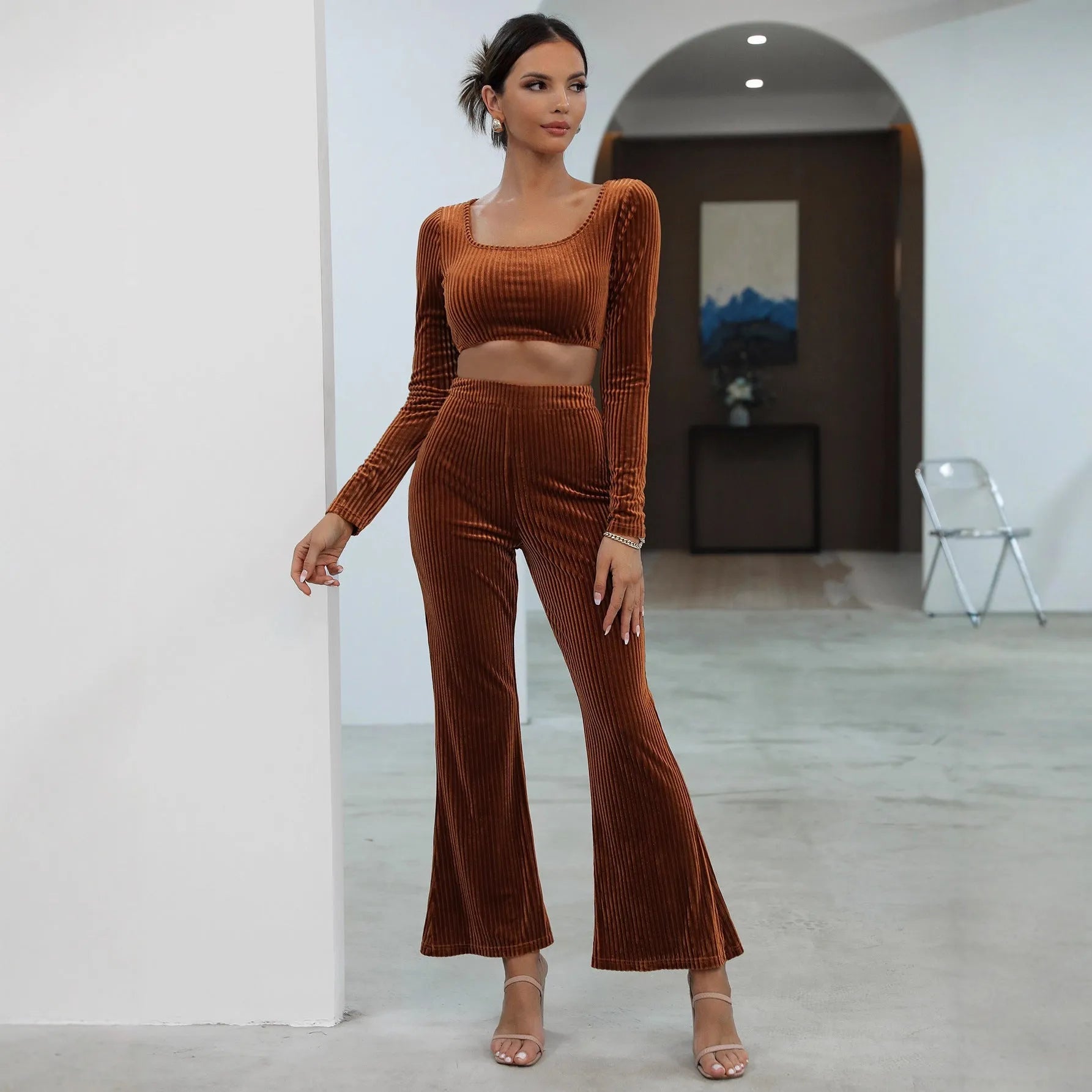 Caramel coloured long sleeve sweater and trousers casual set on a hanger.