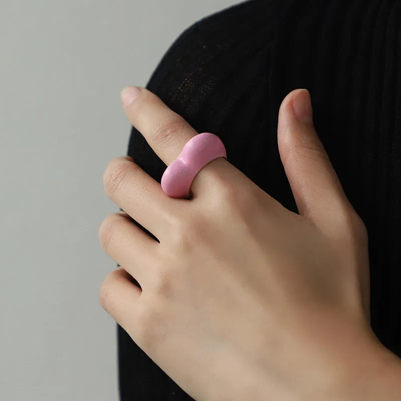 Three-dimensional heart-shaped enamel fashion ring in red, shown from the side.