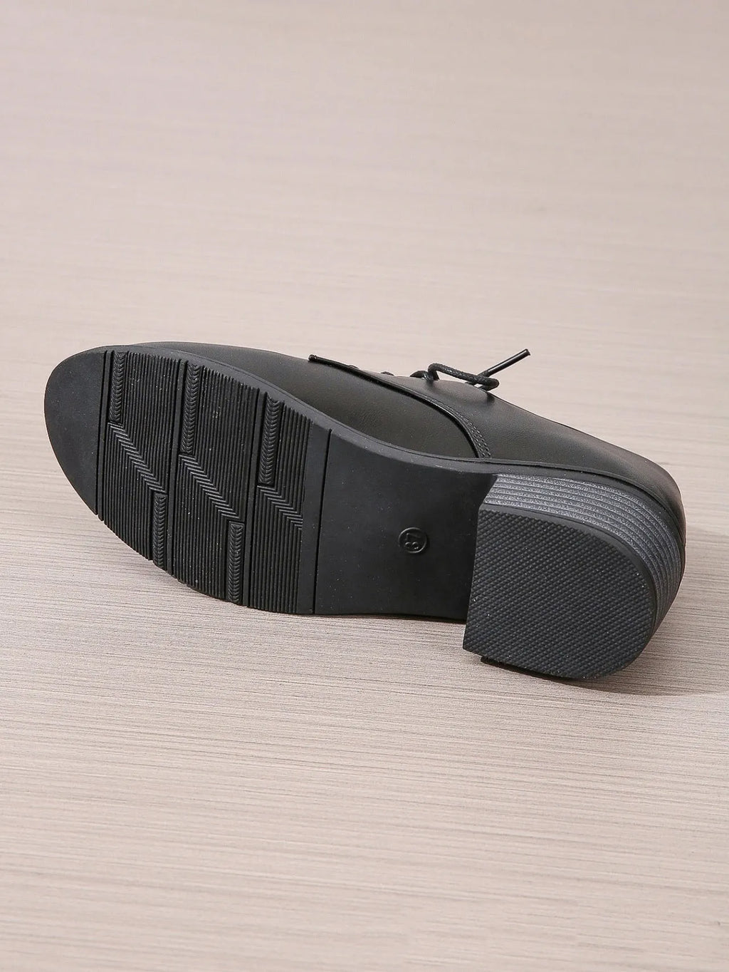 Black women's work shoes with a thick chunky heel and pointed toe.