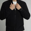Men's loose fit black modal cardigan sweater on model, front view, size L