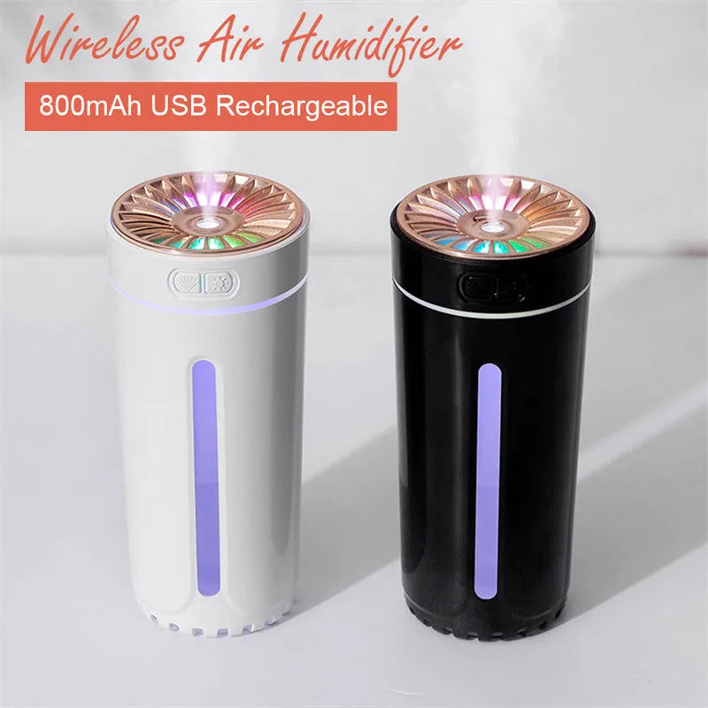 Black wireless ultrasonic humidifier with LED lights sitting in a car cup holder.