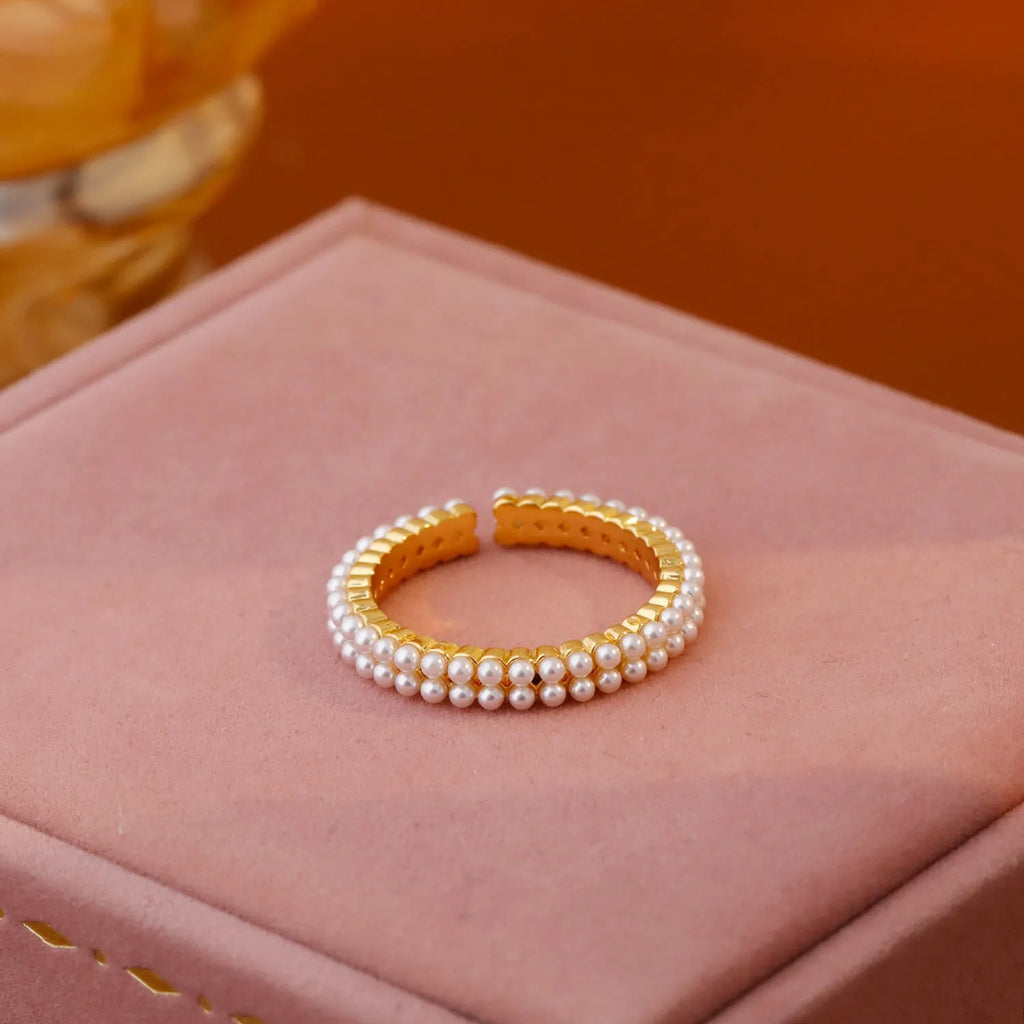 Gold geometric open mouth women's ring with round pearl design elements on copper base