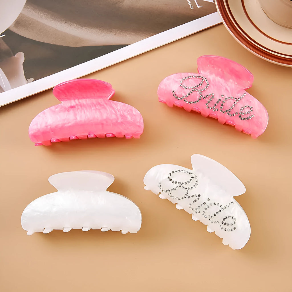 Acrylic hair barrette with diamond pattern and English letters measuring 10cm wide in pink colour
