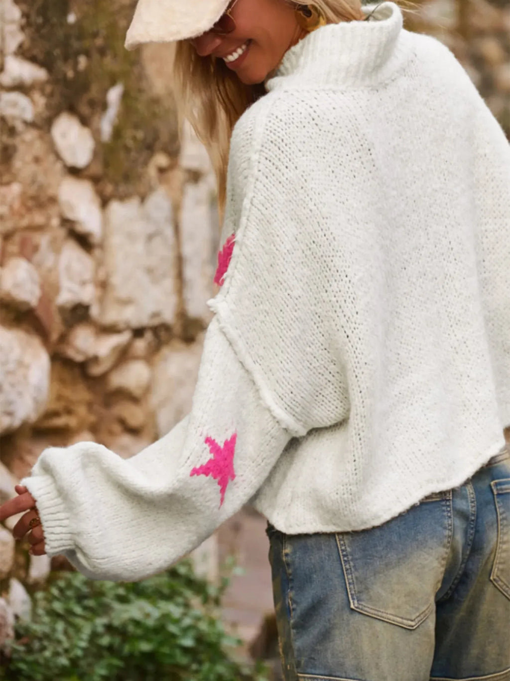 White women's loose turtleneck pullover sweater with a thick imitation velvet fabric and a contrast colour five-pointed star pattern.