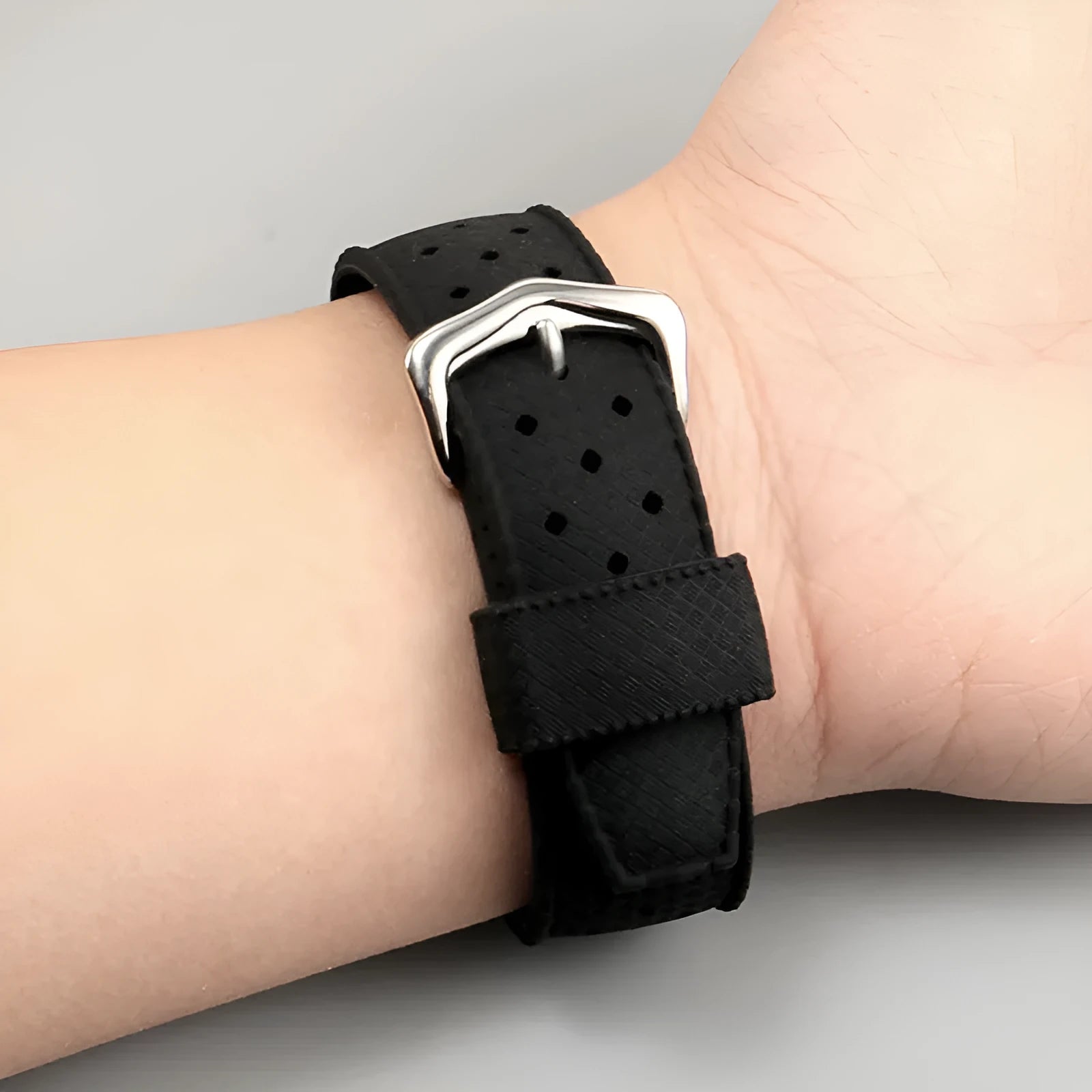 Black silicone watch strap with raised mouth and silver buckle, fitting 20-22mm lugs