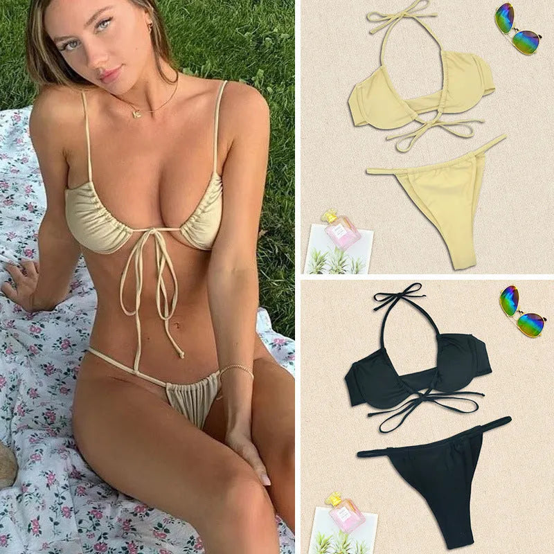 Black and mint green women's two-piece nylon bikini swimsuit on a hanger.