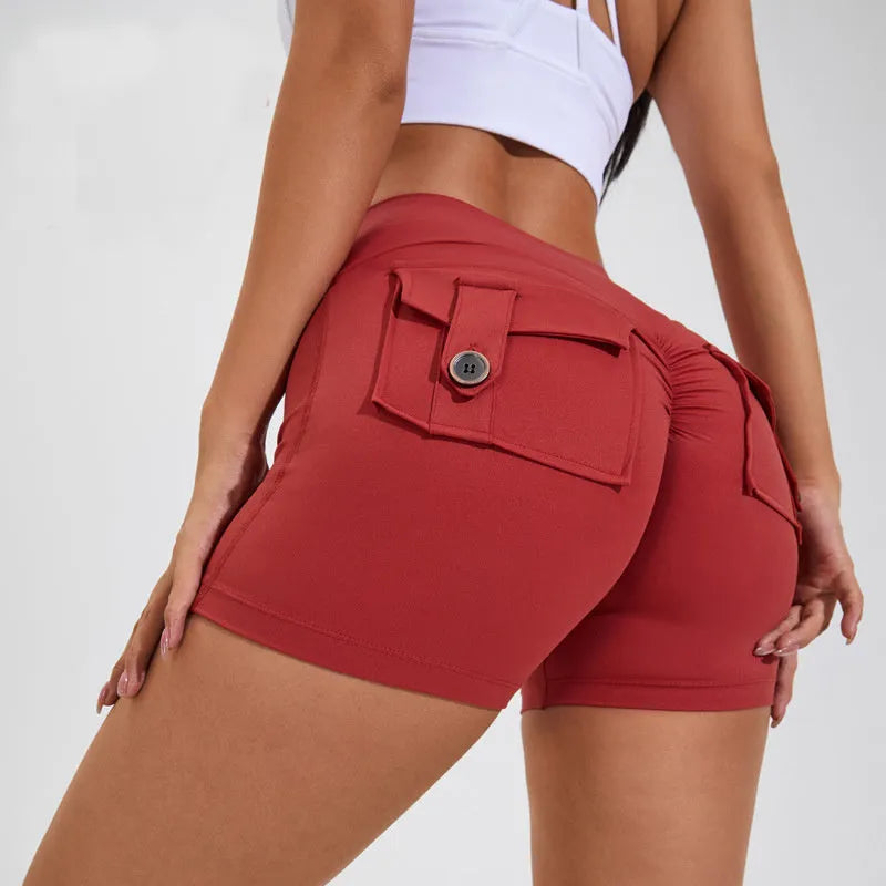 Women's high-waisted fitness shorts with pockets in quick-dry nylon fabric, shown in avocado green colour