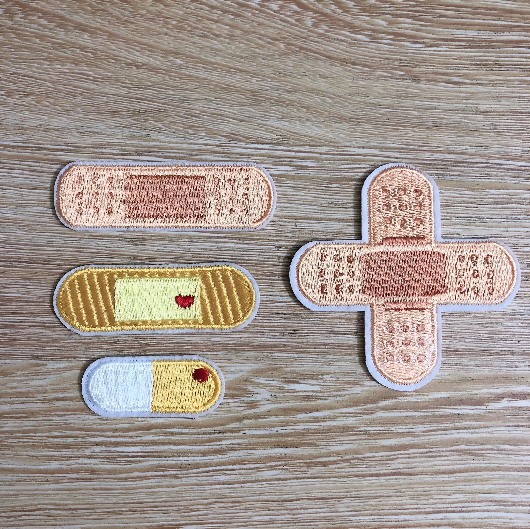 Set of 10 embroidered fabric patches for sewing onto clothing.