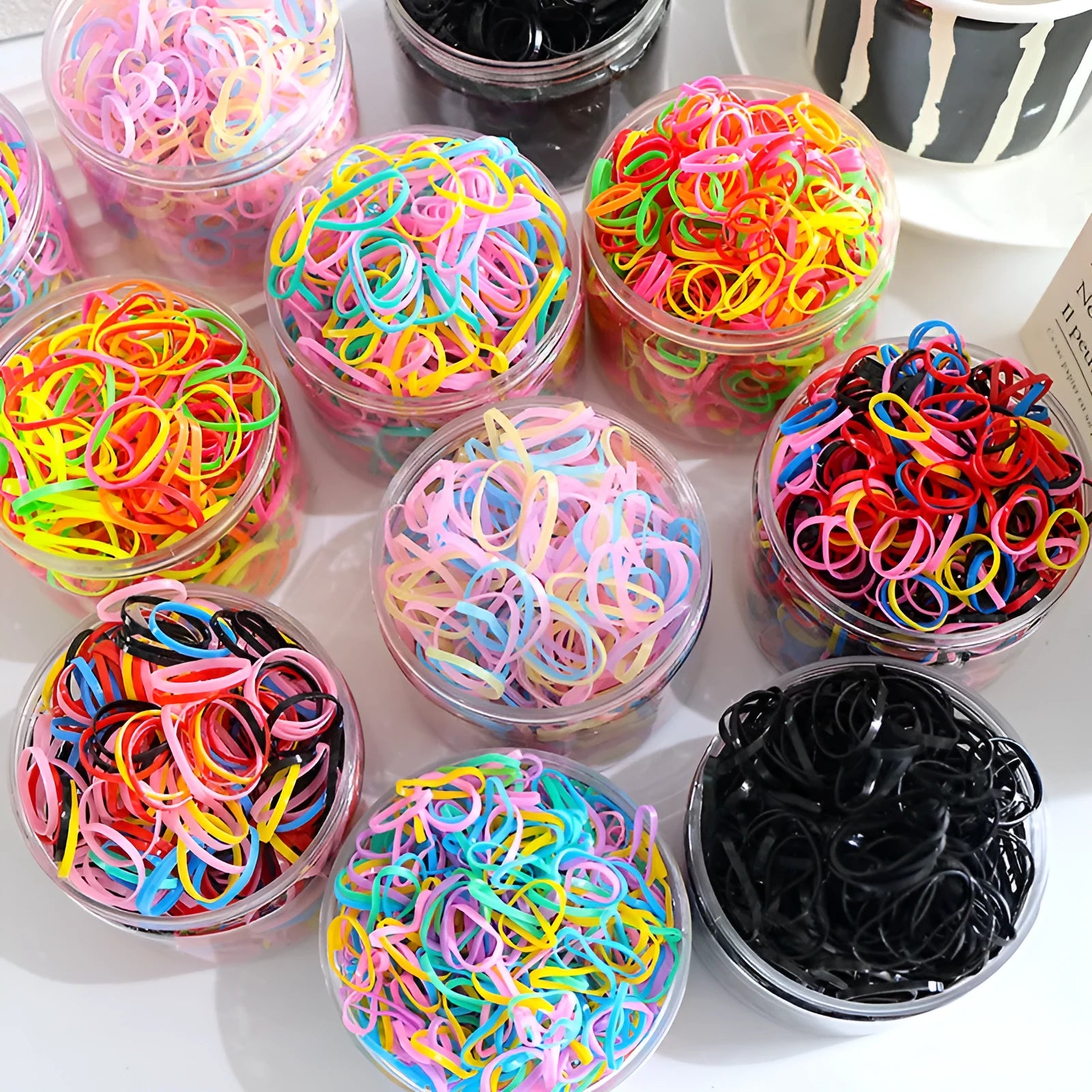 Multicolour TPU baby hair ties in a reusable container for toddlers and girls, 300 or 600 piece pack