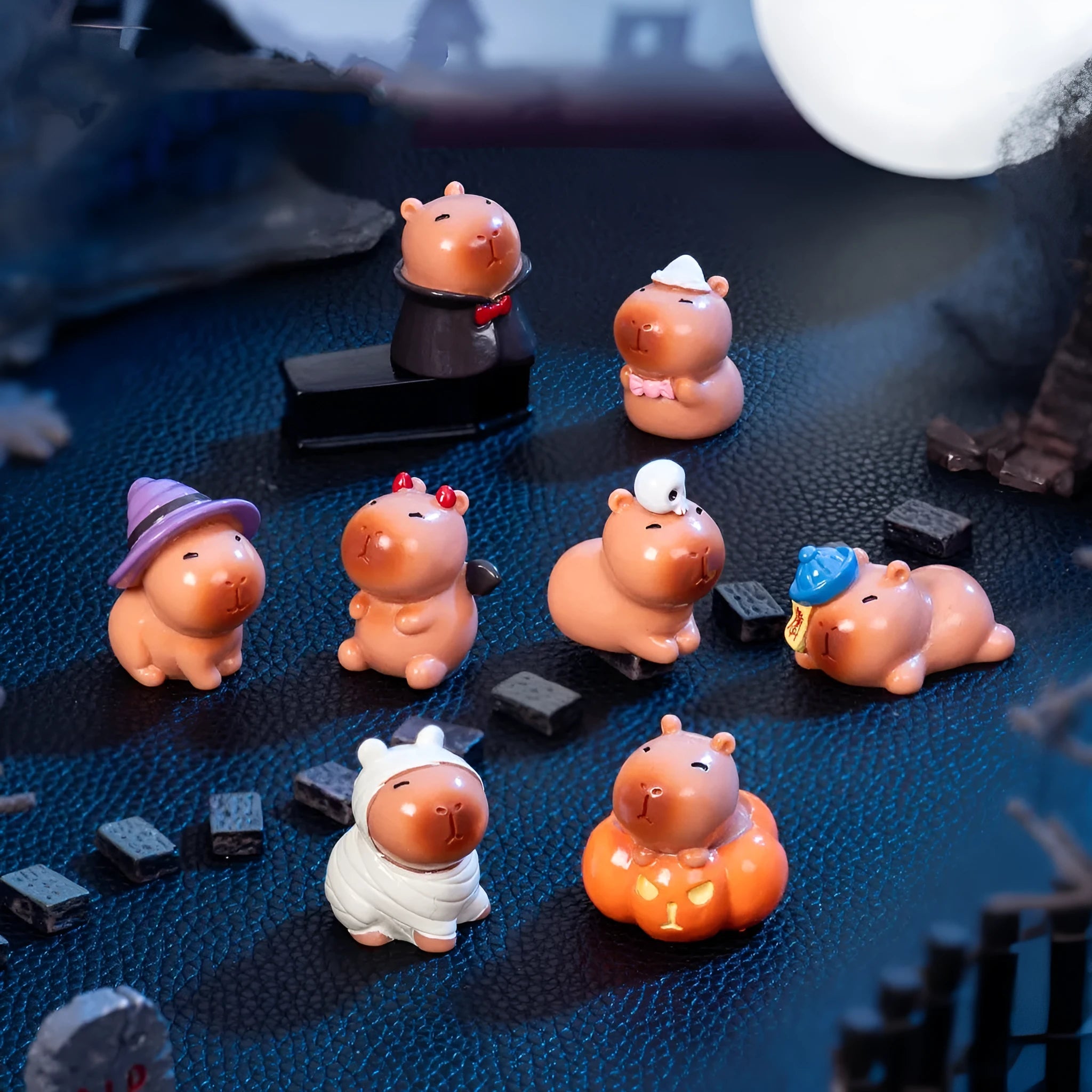 Set of eight micro landscape Halloween capybara resin decorations in assorted costumes including pumpkin and vampire