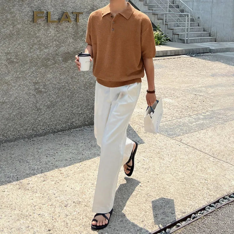 Man wearing a caramel coloured retro knitted polo shirt with short sleeves and an asymmetric design detail.