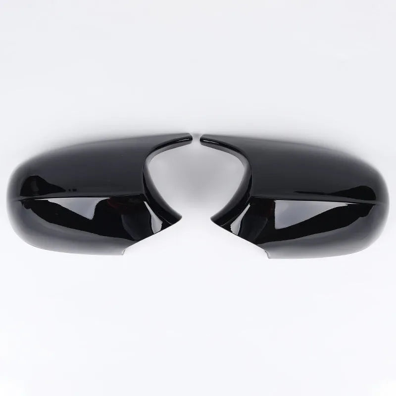 A pair of black and carbon pattern ABS plastic rearview mirror housing shells for a BMW 3 Series E90.