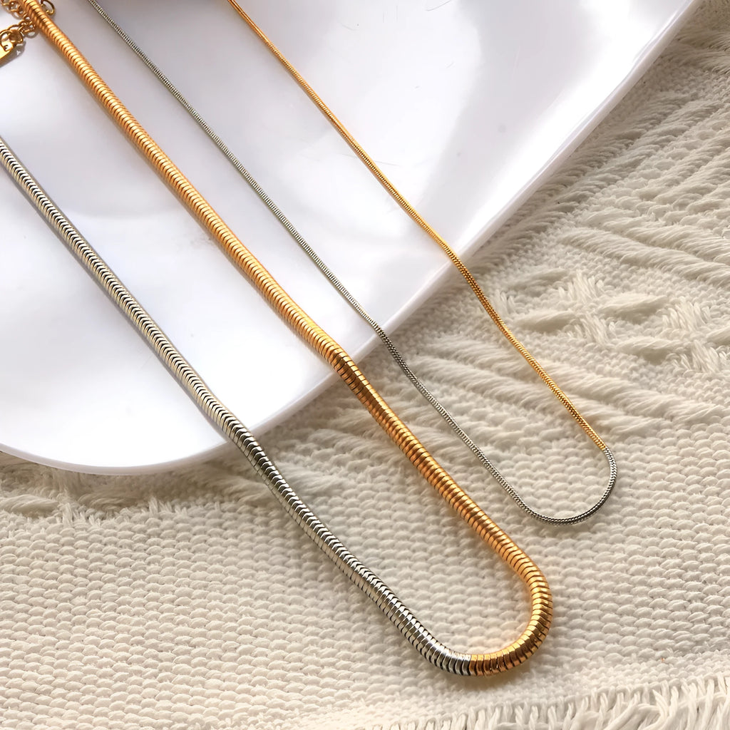 Gold-coloured stainless steel snake bone chain necklace with geometric shapes for women.