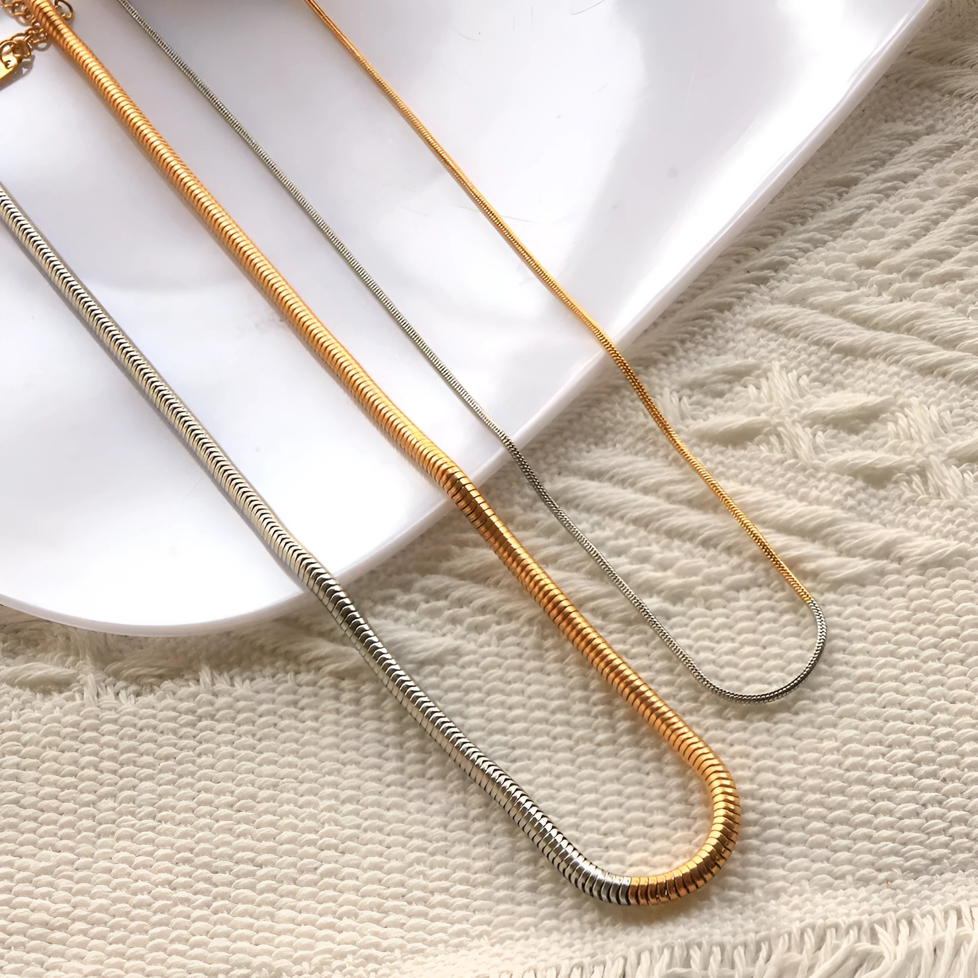 Gold-coloured stainless steel snake bone chain necklace with geometric shapes for women.