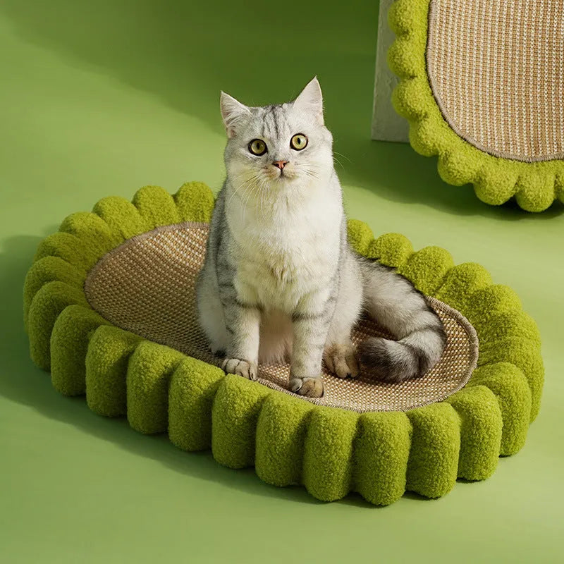 Green oval-shaped cat scratch pad and lounge bed made from textured sisal fabric.