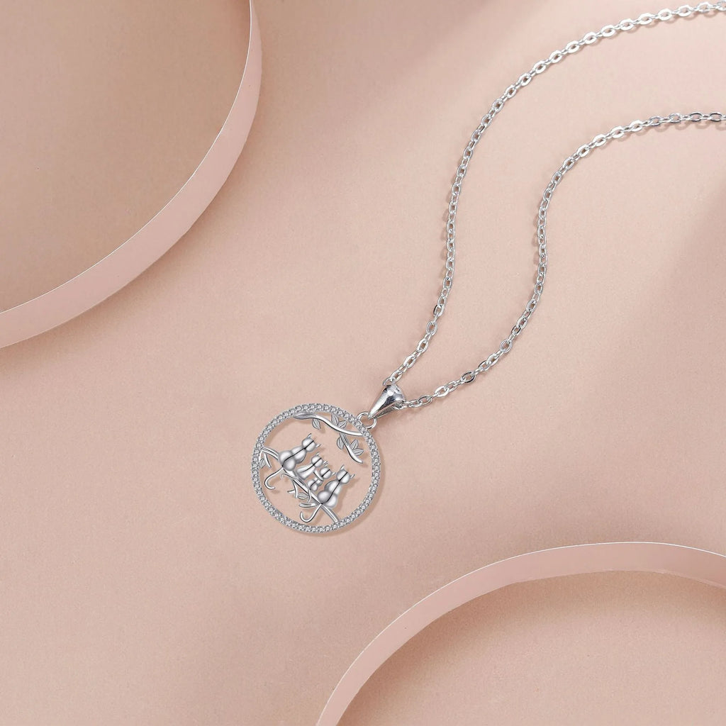 Women's copper necklace with four cat kitten pendants on cross chain, electroplated finish.