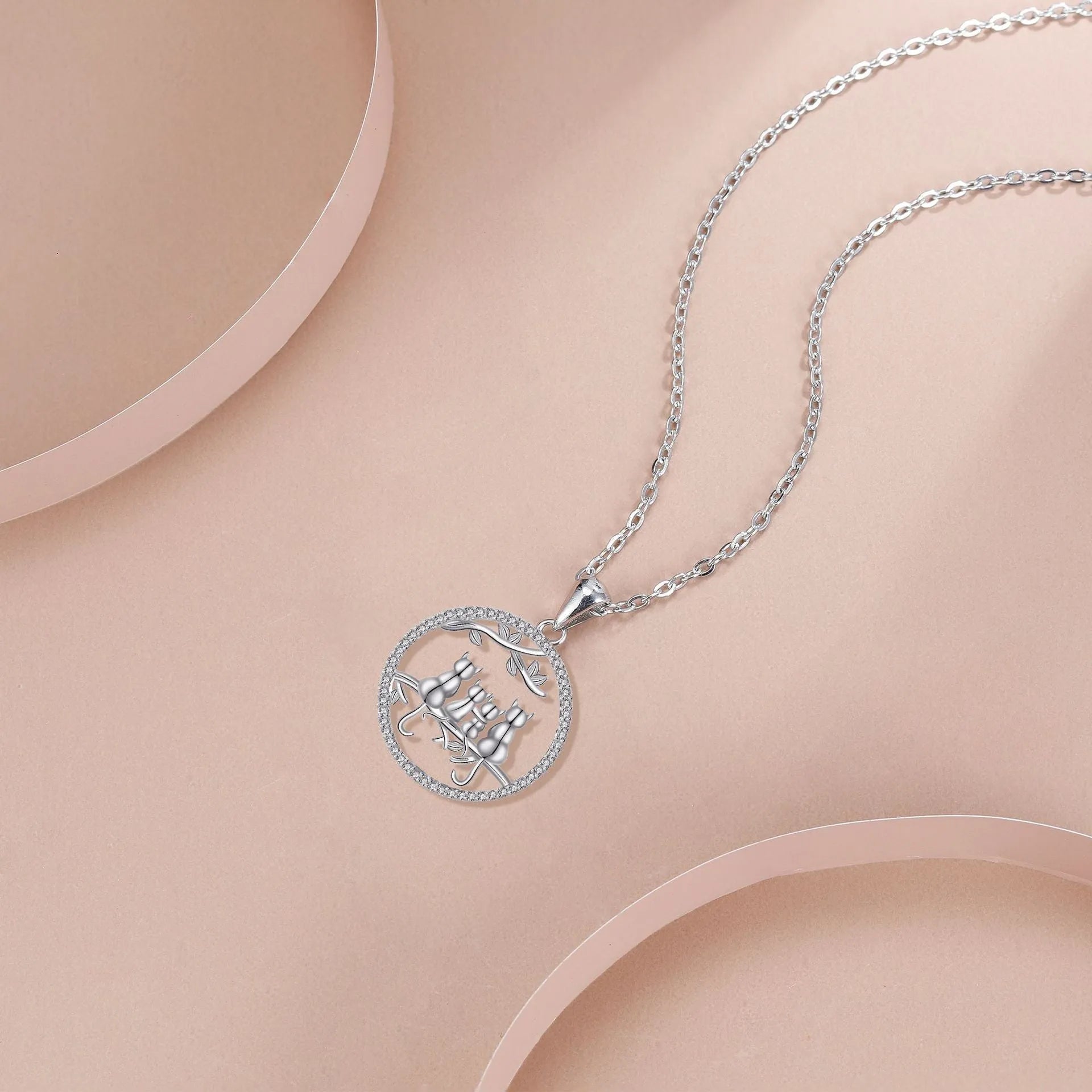 Women's copper necklace with four cat kitten pendants on cross chain, electroplated finish.