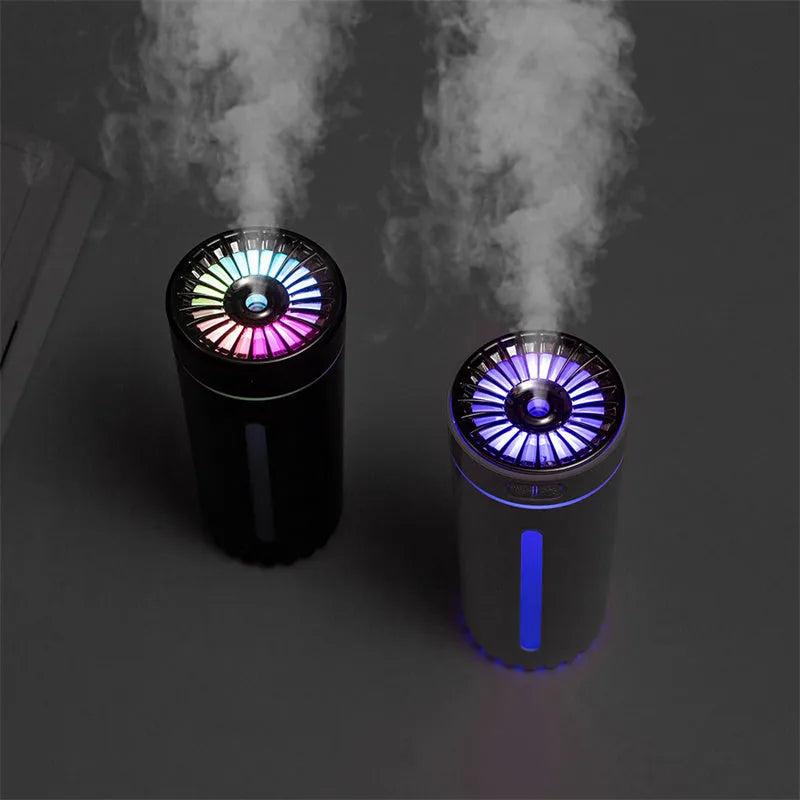 Black wireless ultrasonic humidifier with LED lights sitting in a car cup holder.