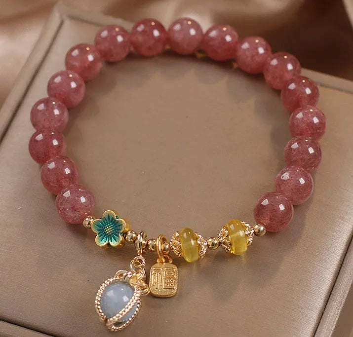 Natural Strawberry Quartz beaded bracelet with rhinestone accents on red alloy base