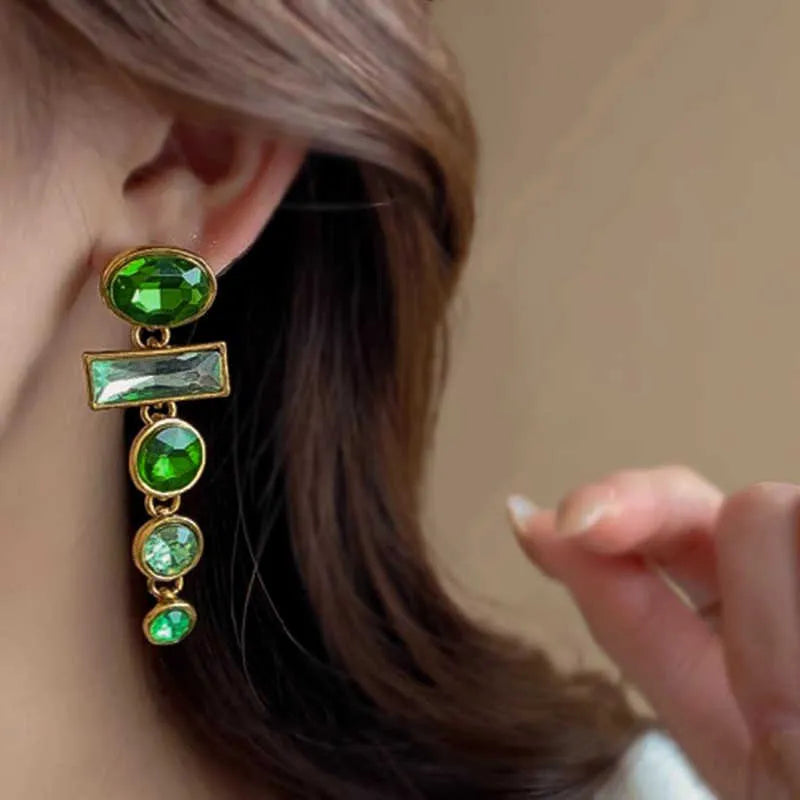 A pair of retro green gradient alloy earrings with geometric shapes and a long tassel design.