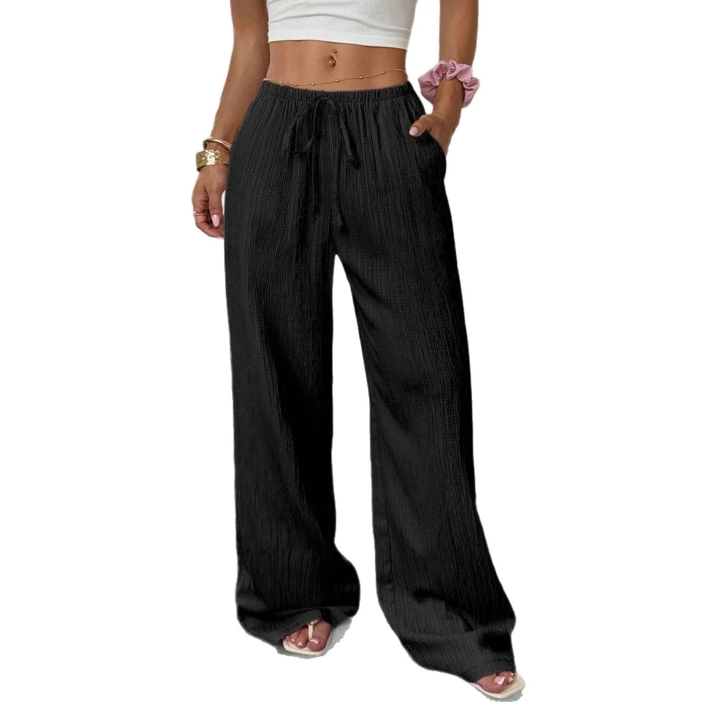 Women's wide-leg trousers with lace-up waist trimming in black or pink colours