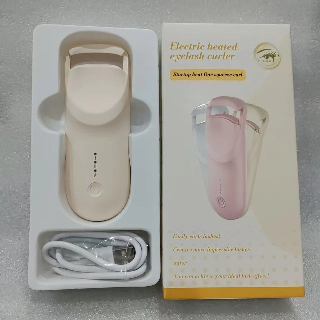 Electric eyelash curler with USB charging cable in cream white colour showing curling mechanism