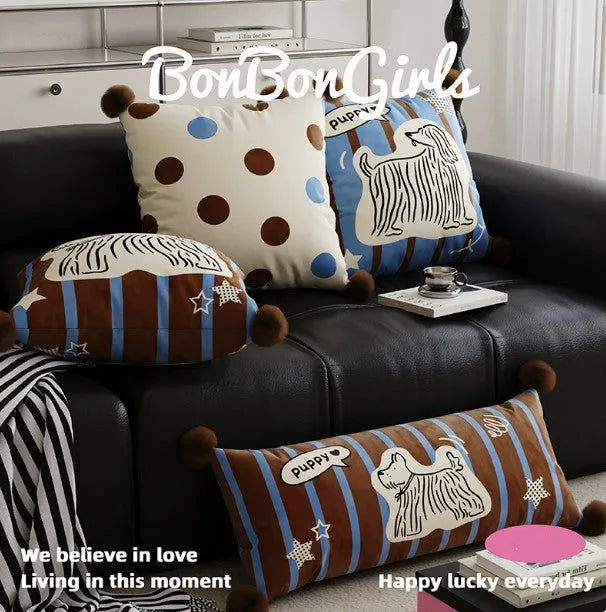 Blue cartoon animal print decorative sofa cushion pillow on a grey couch.