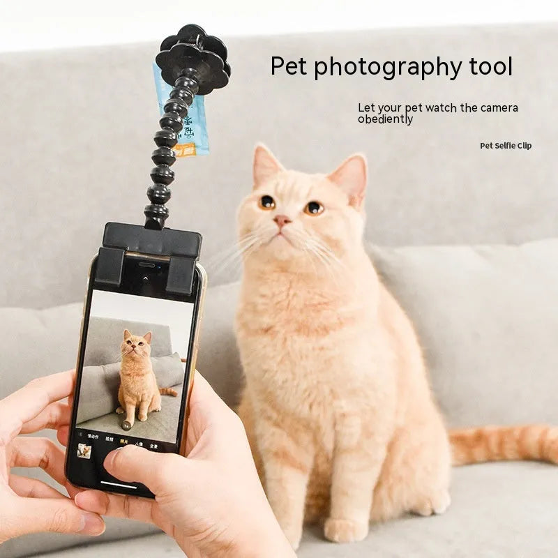 Pet photography selfie stick with clip for snacks in black plastic, showing phone holder and rotatable head