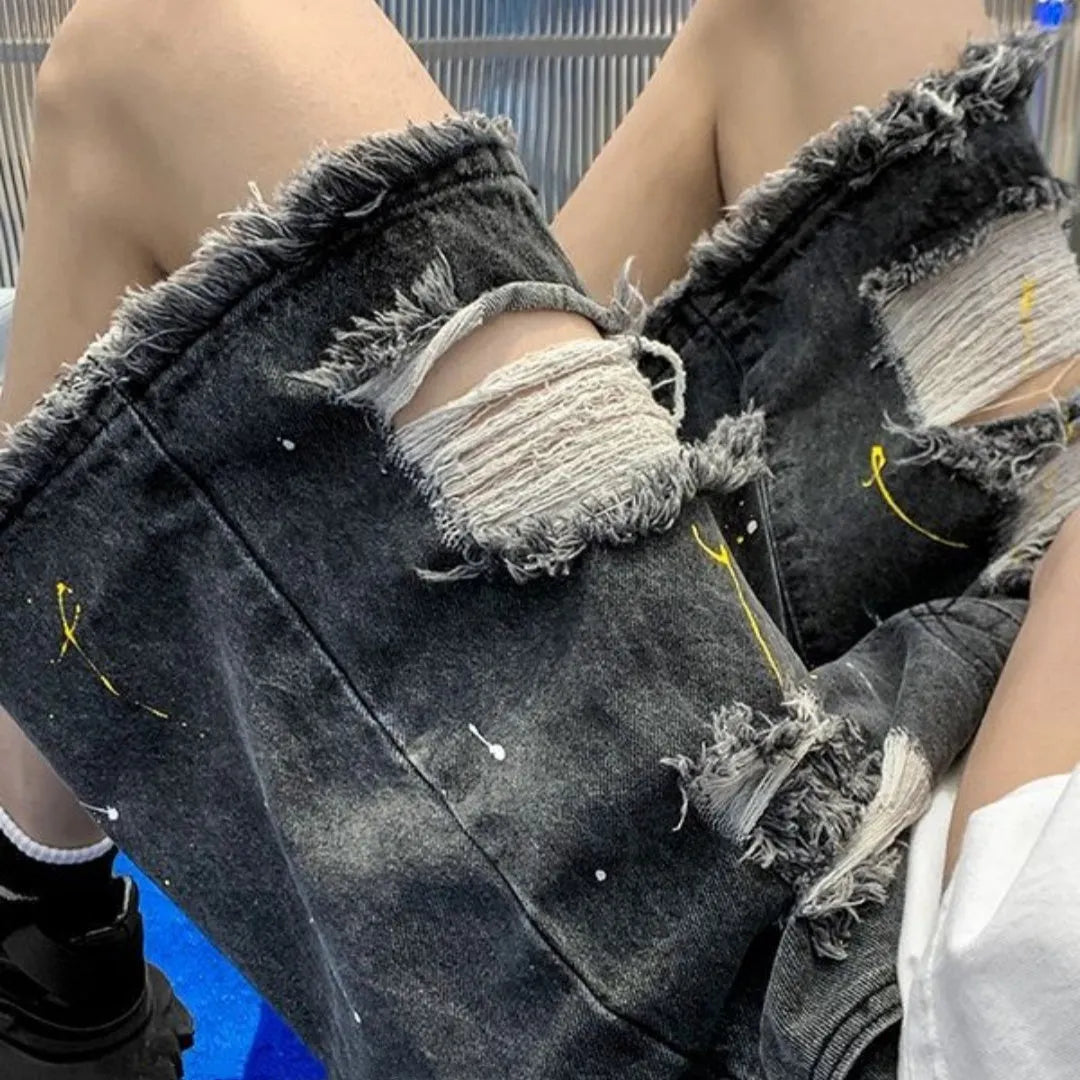 Men's loose-fit denim shorts with water washed hole detail in light blue colour.