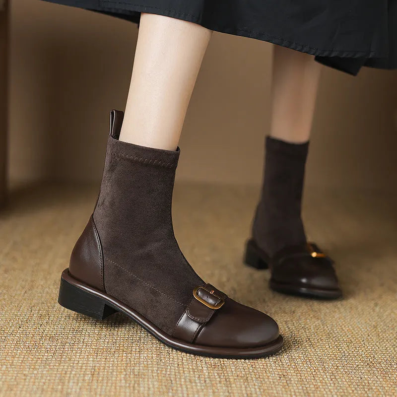 Black women's lace-up Martin boots with low heel and decorative belt buckle stitching on a white background.
