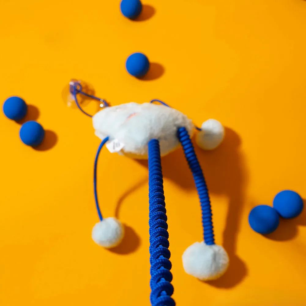 Blue plush cat toy with telescopic elastic rope, ring with bell and mint element on white background