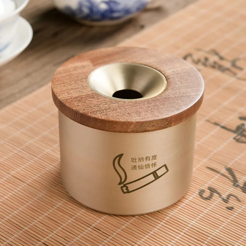 Retro brass and copper ashtray with wooden lid on a living room table.