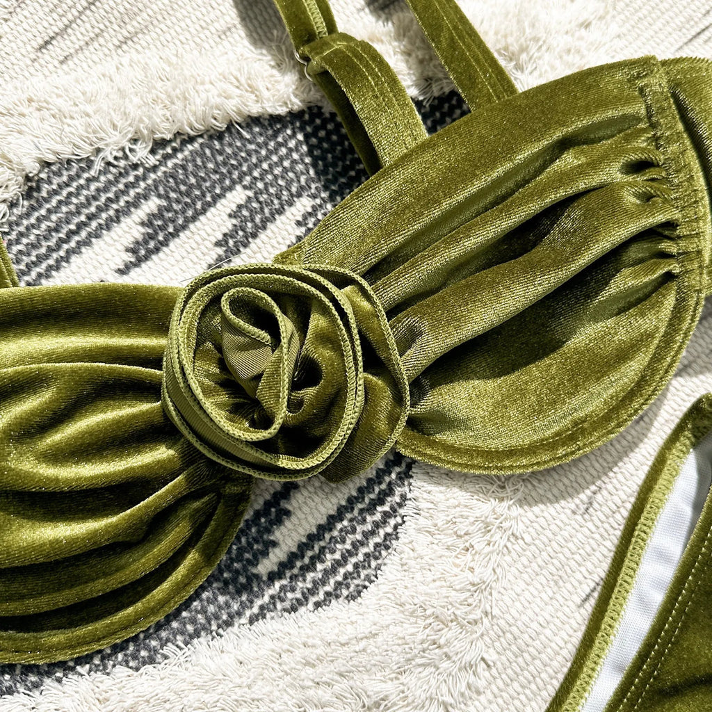 Women's green floral bikini swimsuit set with bra and briefs on a mannequin.