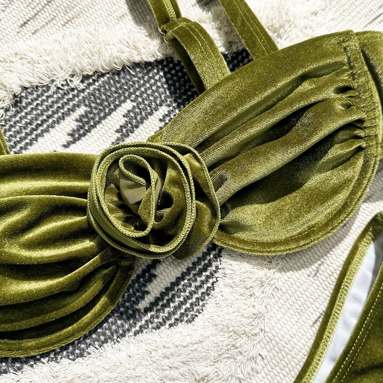Women's green floral bikini swimsuit set with bra and briefs on a mannequin.